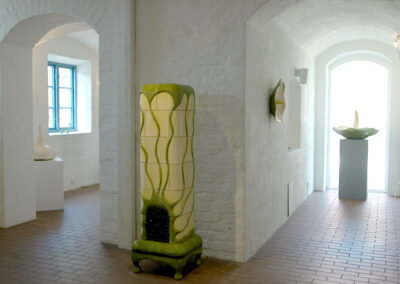 Naples yellow tiled stove, with green looping ornaments (Gothenburg)